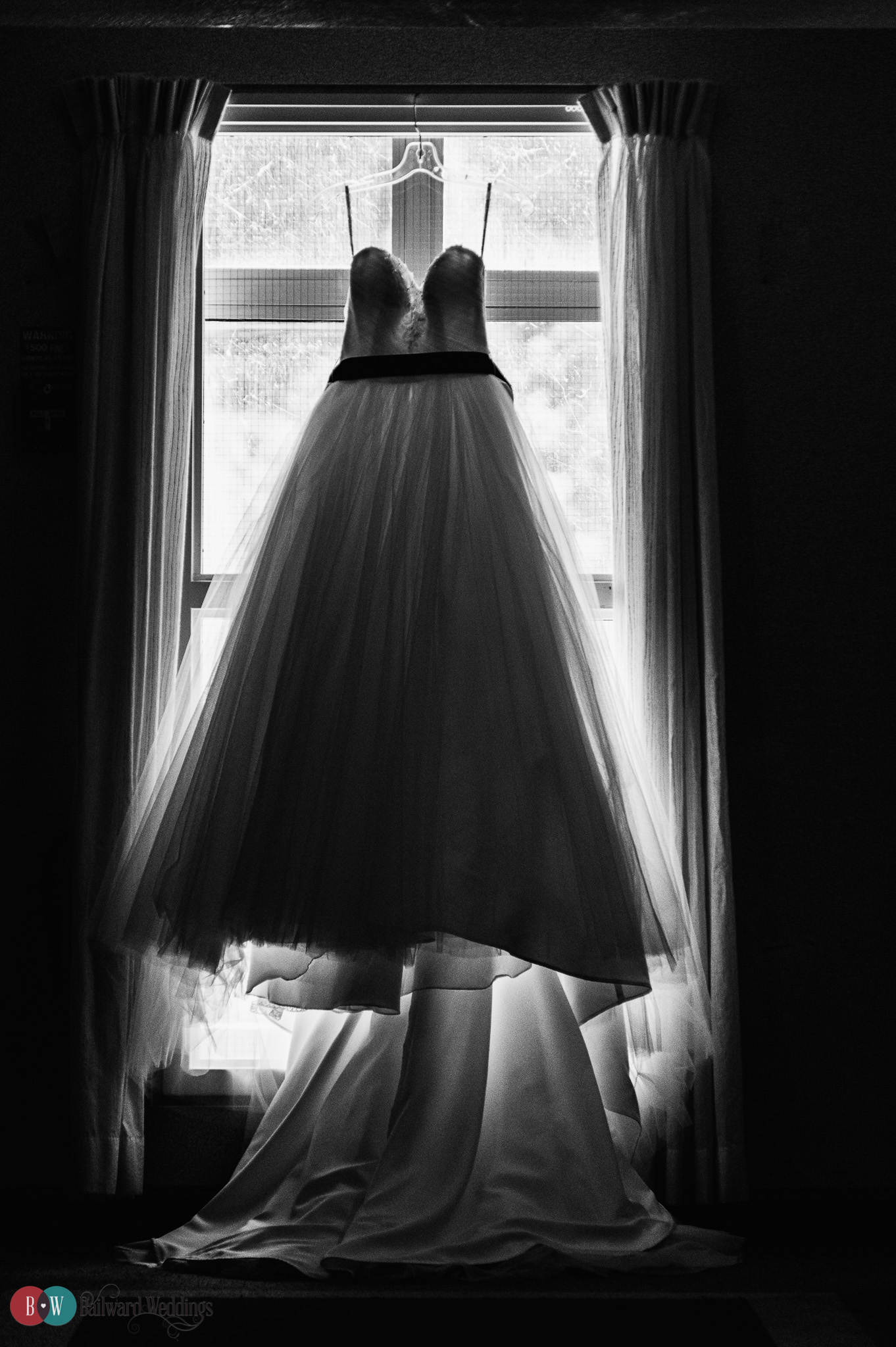 Wedding dress in front of window in Harrison Hot Springs in Black and White