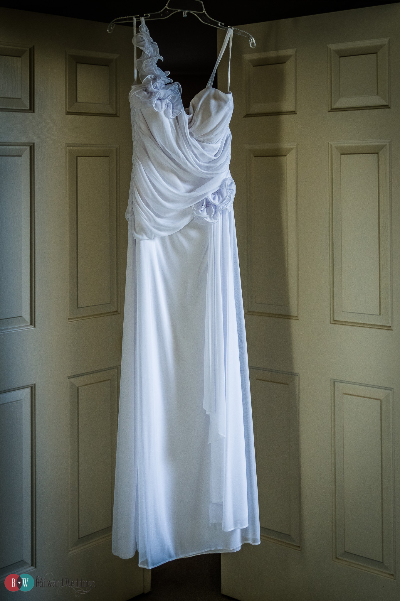 Wedding dress hanging in doorway in Port Moody BC