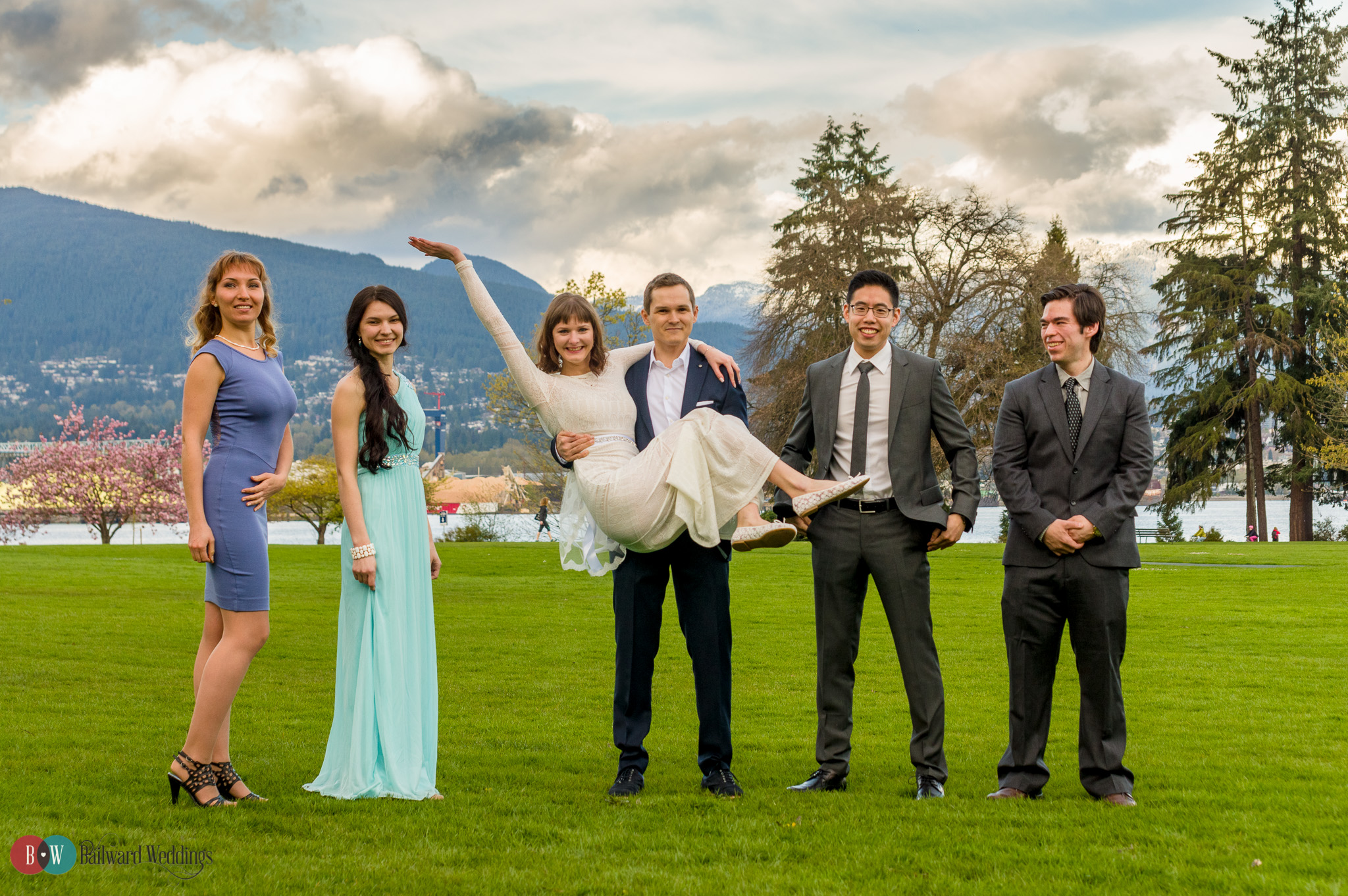 Wedding party with goofy bride and groom in Stanley Park