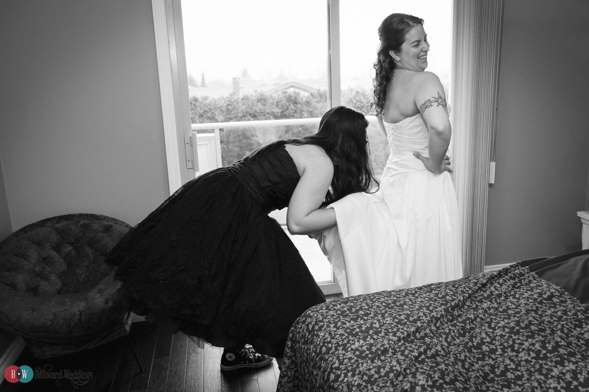 Bride and bridesmaid getting ready, bridesmaid's hand up dress