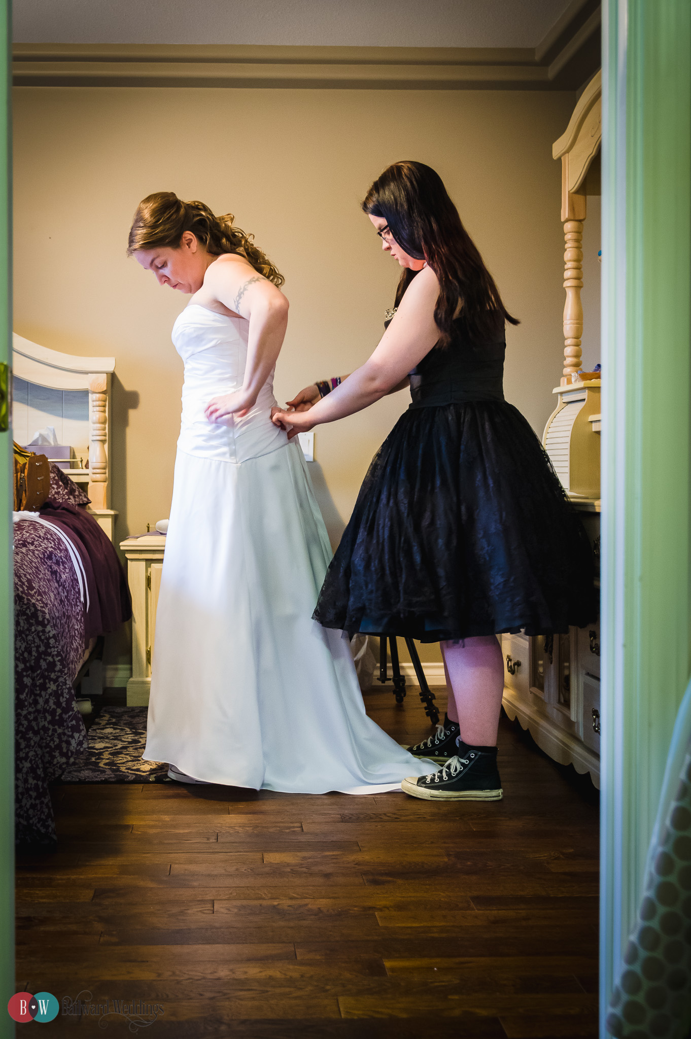 Bride and bridesmaid getting ready