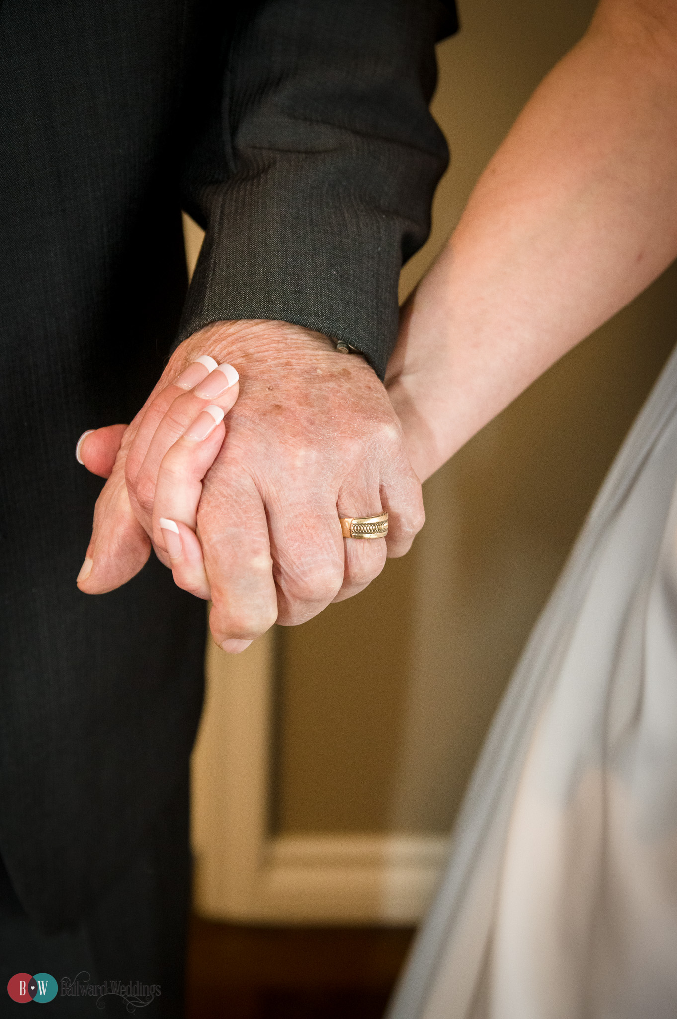 Bride and father of the bride hand in hand