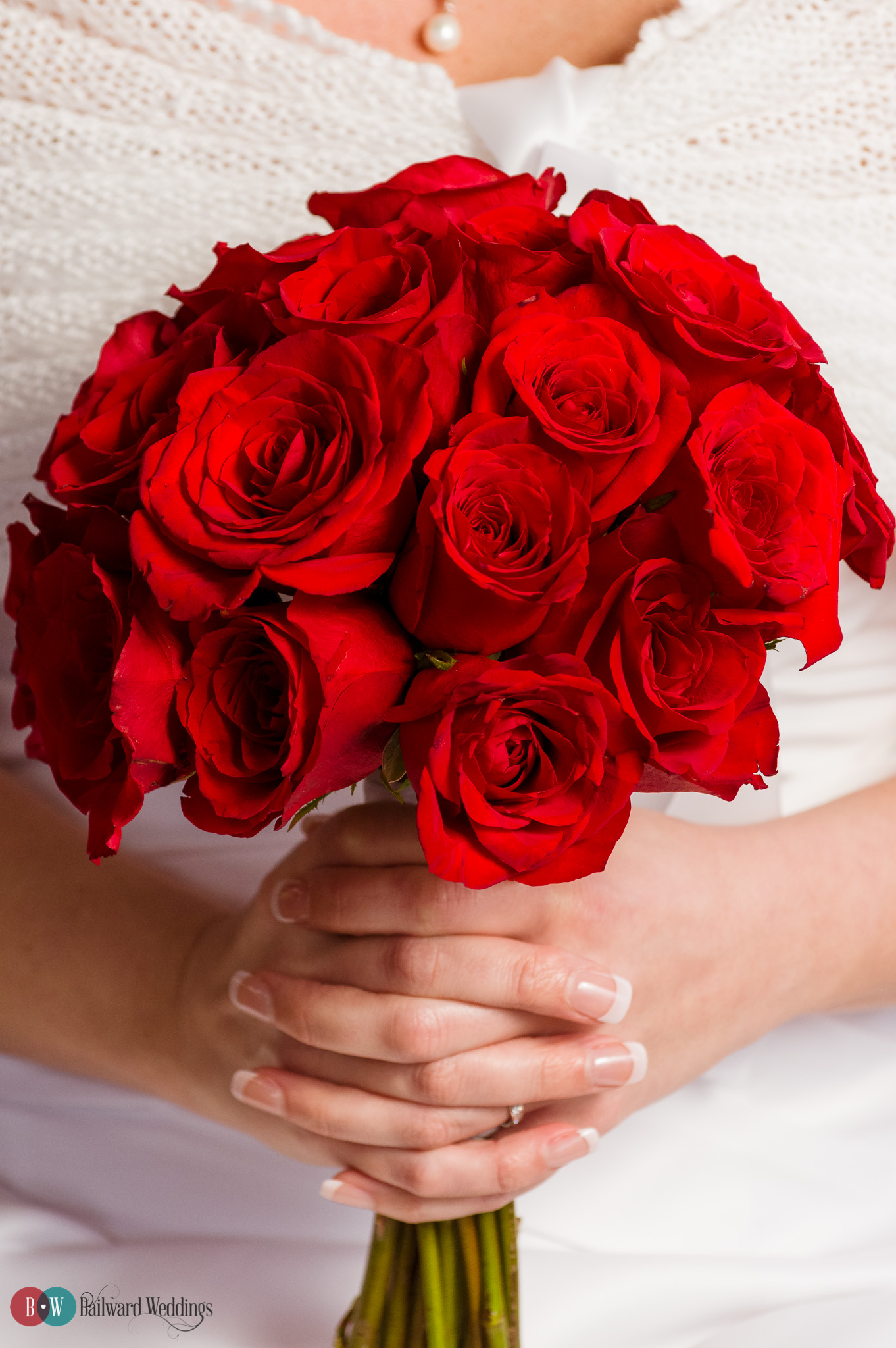 Bride holding red roses