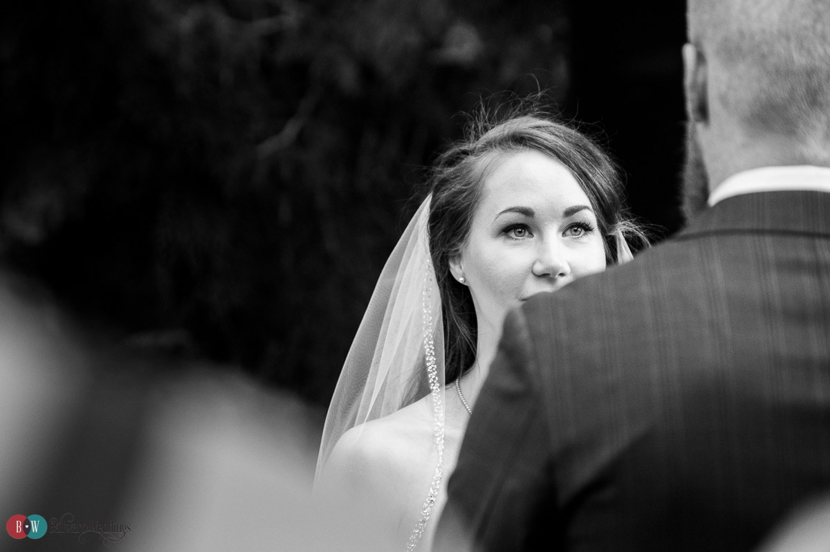 Bride looking at groom over shoulder